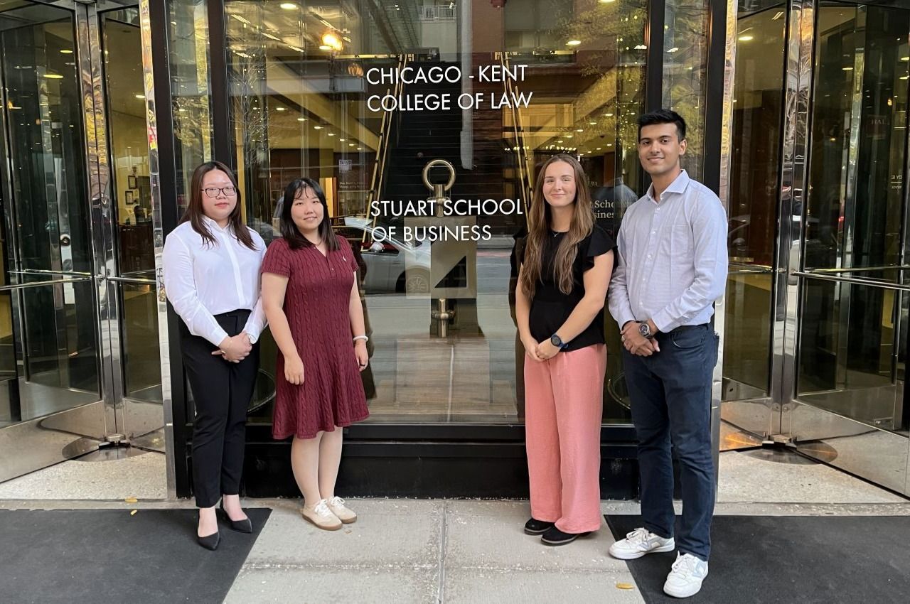 (From left to right) Team members My Thao Doan Pham, Siyuan Wang, Nicole Kadziola, and Elton Thomas stand outside of Stuart School of Business at the Conviser Law Center..